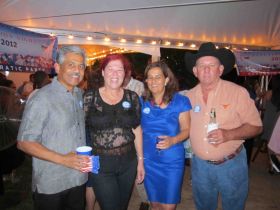 Creole- speaking expat, Howard Oldham in black cowboy hat with wife Wilana in black lace top, pictured at US embassy party in Belize, – Best Places In The World To Retire – International Living